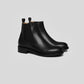 Vegan Chelsea boots - Woman in black leather, featuring handstitched details and a sleek design.