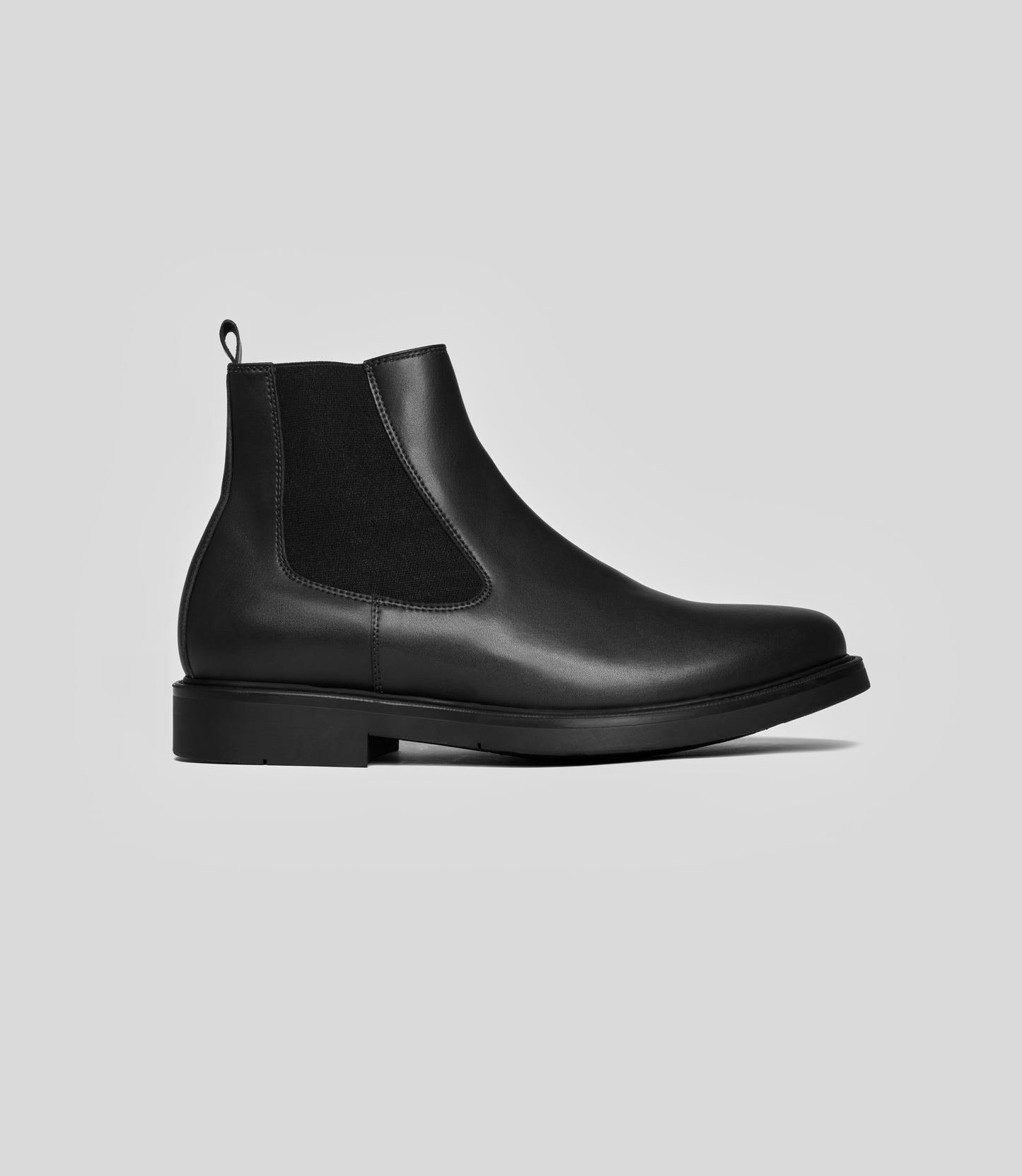 Side view of Vegan Chelsea Boot - Men, elegant black design with elastic side panels, perfect for any occasion.