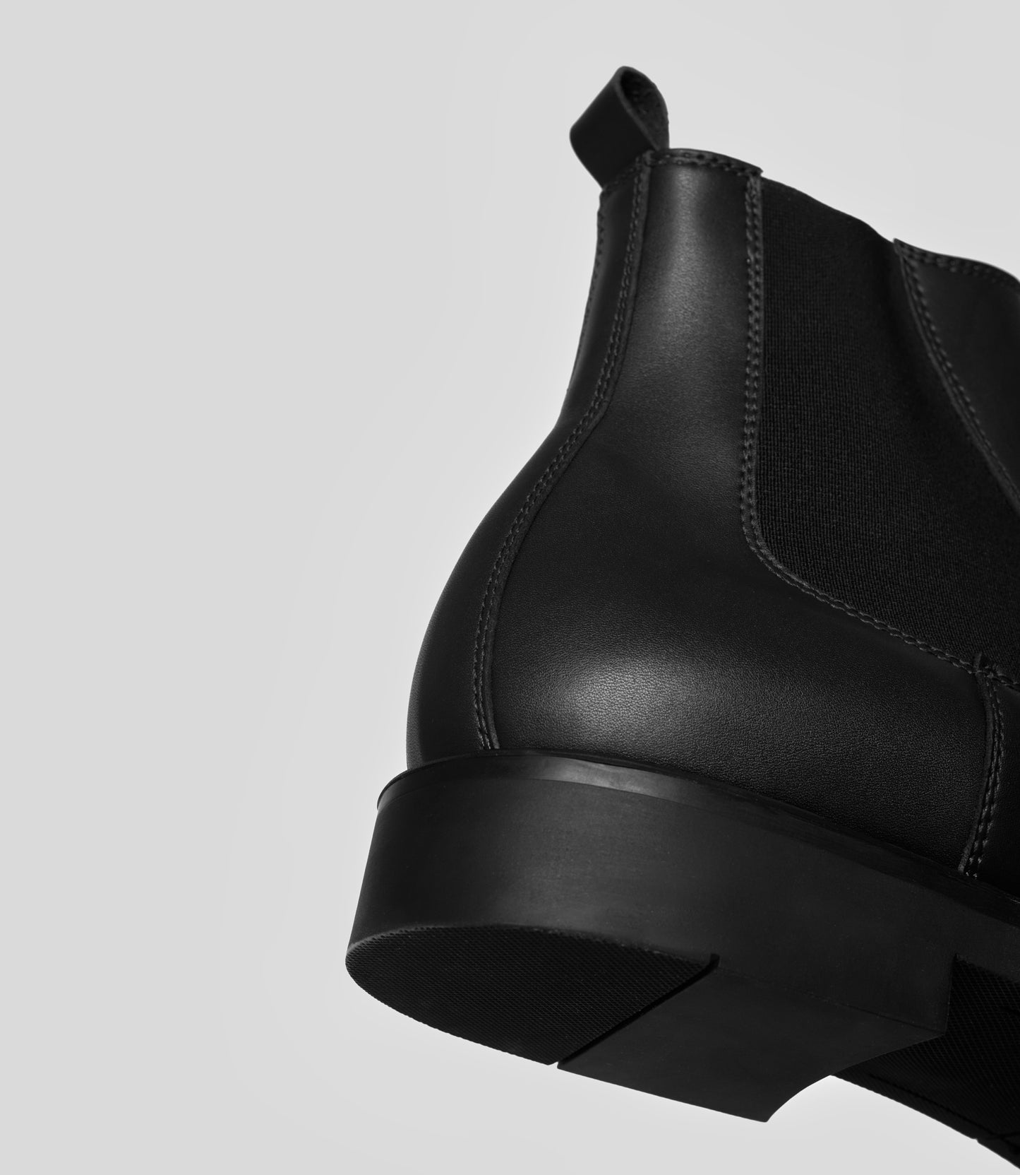 Vegan Chelsea Boot - Men showcasing the elegant design and craftsmanship with a focus on the boot's back and sole.