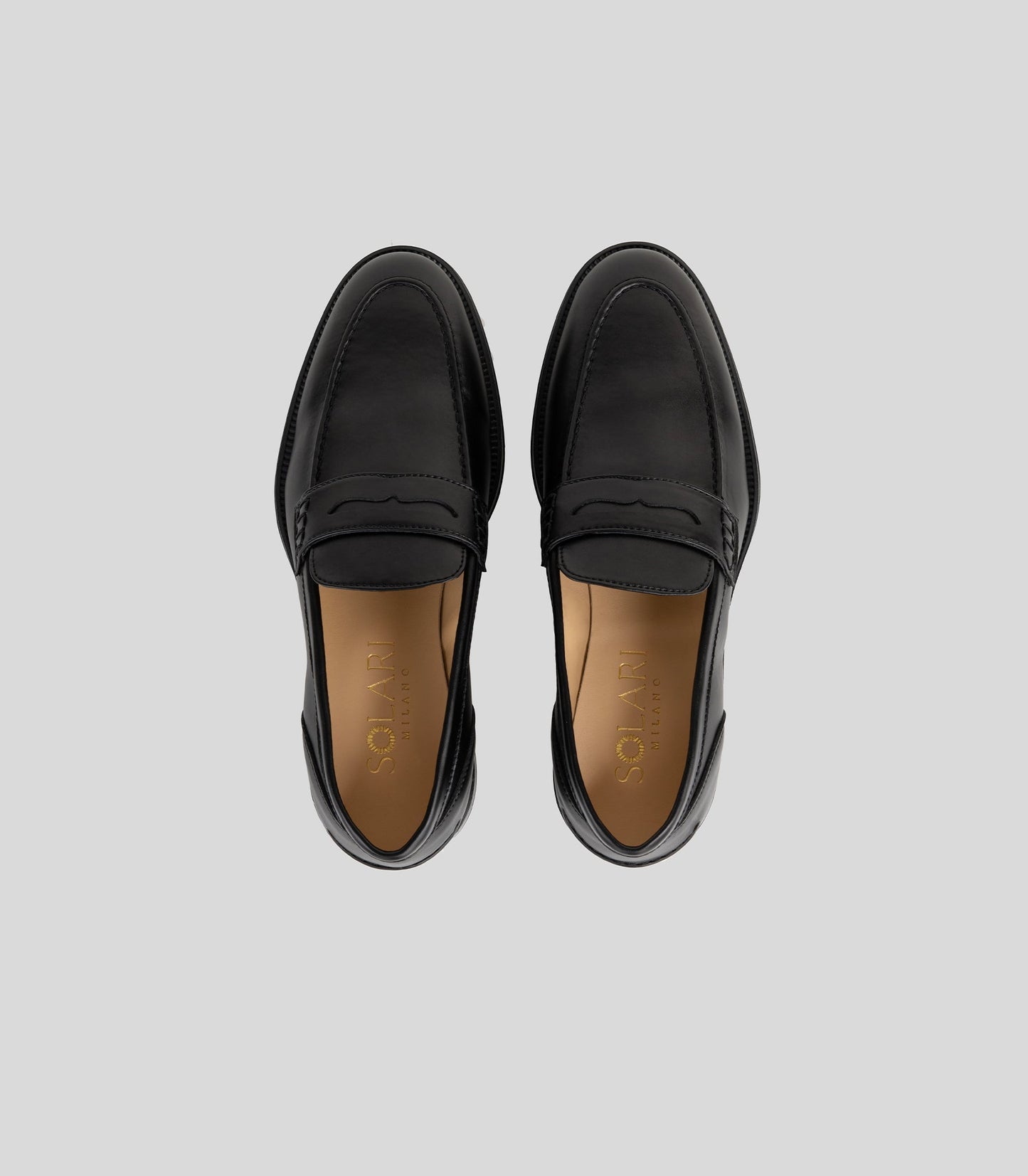 Vegan Loafer - Man in sleek black design with distinctive stitching and comfortable fit from above view.