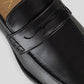 Vegan Loafer - Man showing the black leather upper and distinctive U-shaped stitching detail.