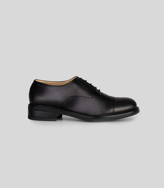 Vegan Oxford - Woman classic black lace-up shoe side view with Blake Construction.