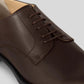 Vegan Derby - Man showing a brown shoe with open lacing and Blake Construction for a versatile style.