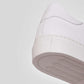 Vegan sneakers handmade in Italy, detail of the heel and sole of a white sneaker.