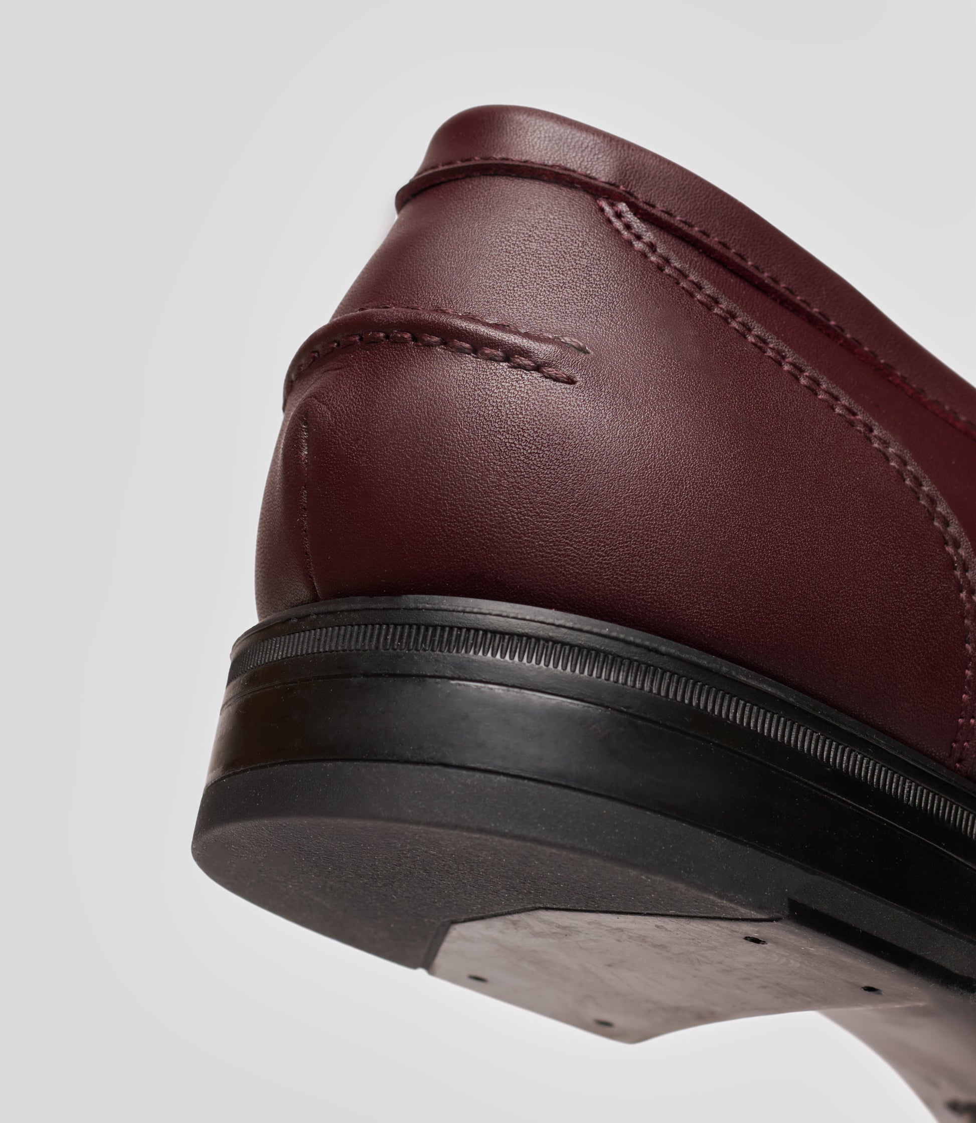 Vegan Loafer - Man showcasing the detailed heel and edge of the shoe, highlighting its stylish design.